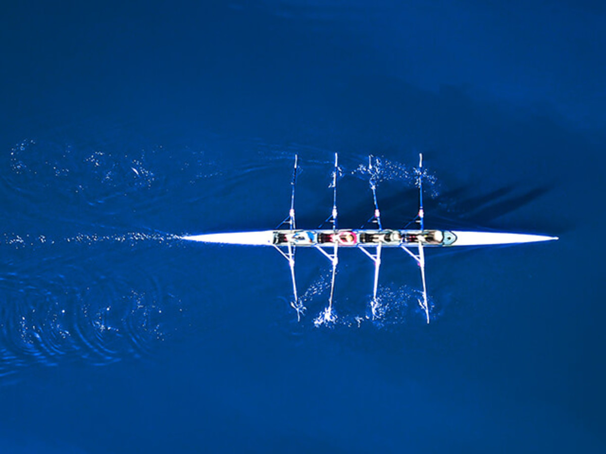 Over head view of rowing team in boat on water